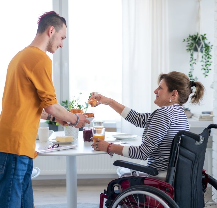 Support worker helping a participant with daily living activities at home