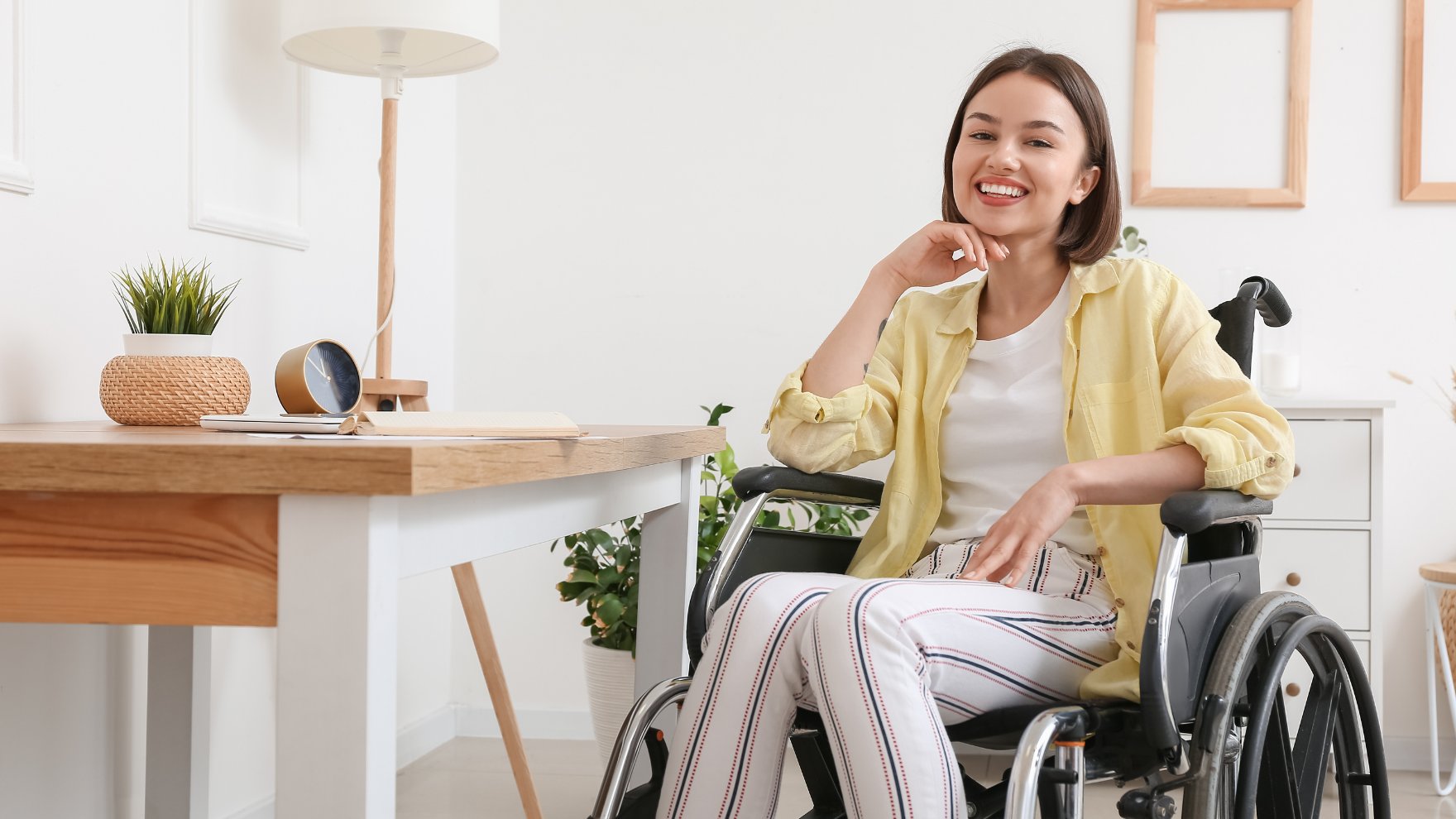 An NDIS participant using a laptop confidently at home
